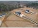 Spacious lot with a newly built home featuring a long driveway, surrounded by lush greenery and mature trees at 2335 Emanuel Church Rd, Rockwell, NC 28138