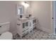 Modern bathroom with double vanity and patterned floor at 2335 Emanuel Church Rd, Rockwell, NC 28138