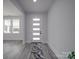 Bright entryway with a modern white door, gray luxury vinyl plank flooring and natural light at 2335 Emanuel Church Rd, Rockwell, NC 28138