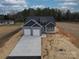 Charming home featuring a two-car garage, complemented by a well-manicured lawn and inviting curb appeal at 2335 Emanuel Church Rd, Rockwell, NC 28138