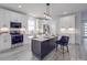 Modern kitchen with white cabinets, a large island, stainless steel appliances, and luxury vinyl plank flooring at 2335 Emanuel Church Rd, Rockwell, NC 28138