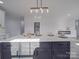 Modern kitchen island with quartz countertops and a stylish light fixture at 2335 Emanuel Church Rd, Rockwell, NC 28138