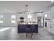 Modern kitchen with white cabinets, a large island, stainless steel appliances, and luxury vinyl plank flooring at 2335 Emanuel Church Rd, Rockwell, NC 28138