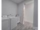 Convenient laundry room with washer, dryer, and sink at 2335 Emanuel Church Rd, Rockwell, NC 28138
