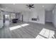 Open living room with fireplace and vinyl plank flooring at 2335 Emanuel Church Rd, Rockwell, NC 28138