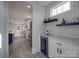 Convenient wet bar with wine cooler, quartz countertops, and dark wood shelving at 2335 Emanuel Church Rd, Rockwell, NC 28138