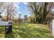 Large backyard with a grassy area and mature trees at 429 Dare Dr, Charlotte, NC 28206