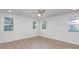 Spacious bedroom with hardwood floors, ceiling fan, and multiple windows at 429 Dare Dr, Charlotte, NC 28206