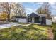 Dark gray house with a white fence and a small yard at 429 Dare Dr, Charlotte, NC 28206