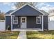 Gray exterior of charming craftsman style home with a covered porch and landscaped yard at 429 Dare Dr, Charlotte, NC 28206