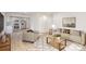 Bright living room showcasing an open floor plan connecting to a modern kitchen with stainless steel appliances at 429 Dare Dr, Charlotte, NC 28206