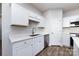 White kitchen with stainless steel appliances and wood-look flooring at 805 Cedar St, Salisbury, NC 28144