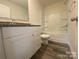 Well-lit bathroom featuring granite countertop and tub and shower combo at 104 Salem Springs Ln, Statesville, NC 28625