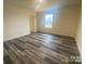Spacious bedroom with wood-look flooring, natural light, and a neutral color palette at 104 Salem Springs Ln, Statesville, NC 28625