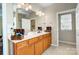 Bathroom with double vanity, wooden cabinets, mirrors and decorative items at 2221 Hartwell Ln, Fort Mill, SC 29707