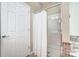 Bathroom featuring a shower with white curtain and glass door, and a white door with chrome handle at 2221 Hartwell Ln, Fort Mill, SC 29707