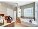 Bright bathroom featuring a soaking tub, tiled floors, and vanity at 2221 Hartwell Ln, Fort Mill, SC 29707