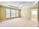 Spacious bedroom with tray ceilings, large windows, and ensuite bathroom entrance at 2221 Hartwell Ln, Fort Mill, SC 29707