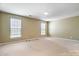 Bright bedroom featuring neutral walls, carpet floors, and natural light from two windows at 2221 Hartwell Ln, Fort Mill, SC 29707