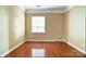 A sunlit, serene bedroom offering ample space and hardwood floors at 2221 Hartwell Ln, Fort Mill, SC 29707
