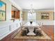 Formal dining room with modern table, hardwood floors, and natural light at 2221 Hartwell Ln, Fort Mill, SC 29707