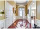 Inviting foyer with hardwood floors, decorative rug, high ceilings, and wainscoting at 2221 Hartwell Ln, Fort Mill, SC 29707