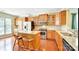 Well-equipped kitchen with stainless steel appliances, wood cabinets, and kitchen island with seating at 2221 Hartwell Ln, Fort Mill, SC 29707