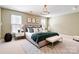 Spacious main bedroom with a large window, stylish chandelier, and well-coordinated modern decor at 2221 Hartwell Ln, Fort Mill, SC 29707