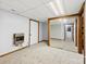 Basement featuring neutral carpet, mirrored closet doors, and a wall-mounted heater at 5034 Clearwater Lake Rd, Mount Holly, NC 28120