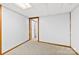 Unfinished basement space with neutral carpet and paneled doorway at 5034 Clearwater Lake Rd, Mount Holly, NC 28120
