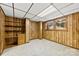 Finished basement features wood-paneled walls, built-in shelving and a window at 5034 Clearwater Lake Rd, Mount Holly, NC 28120