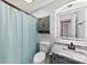 Bathroom featuring a shower with curtain, gray vanity and a granite countertop sink at 5034 Clearwater Lake Rd, Mount Holly, NC 28120