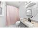 Bathroom featuring a shower with curtain, gray vanity and a granite countertop sink at 5034 Clearwater Lake Rd, Mount Holly, NC 28120