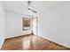 A bright bedroom with hardwood floors, ceiling fan and a window with natural light at 5034 Clearwater Lake Rd, Mount Holly, NC 28120