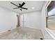 Bright bedroom with gray carpet, ceiling fan, a window, and multiple closets and entryways at 5034 Clearwater Lake Rd, Mount Holly, NC 28120