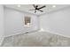 Bedroom with gray carpet, ceiling fan, and a window with natural light at 5034 Clearwater Lake Rd, Mount Holly, NC 28120