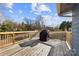 View of the outdoor wooden deck featuring a grill, perfect for entertaining and enjoying the open air at 5034 Clearwater Lake Rd, Mount Holly, NC 28120
