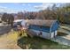 Exterior view of the two-story home with a deck, showcasing its architecture and surroundings at 5034 Clearwater Lake Rd, Mount Holly, NC 28120