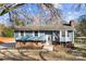 Charming blue home featuring brick accents and a well-manicured front yard at 5034 Clearwater Lake Rd, Mount Holly, NC 28120