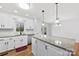 Bright white kitchen featuring granite countertops, stainless steel appliances, and modern fixtures at 5034 Clearwater Lake Rd, Mount Holly, NC 28120