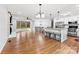 Open-concept living area with fireplace, bay window and kitchen with an island and seating at 5034 Clearwater Lake Rd, Mount Holly, NC 28120
