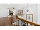 A living room with hardwood floors, a fireplace, staircase and chandelier at 5034 Clearwater Lake Rd, Mount Holly, NC 28120