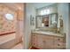 Charming bathroom features floral wallpaper, a vanity with a granite countertop, and a tub at 857 Providence Rd, Lancaster, SC 29720