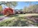 Inviting exterior view of a brick ranch home, mature trees, and a sprawling landscaped lawn at 857 Providence Rd, Lancaster, SC 29720