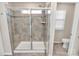 Contemporary bathroom featuring a glass-enclosed shower with tiled walls and built-in bench at 913 Deep River Way, Waxhaw, NC 28173