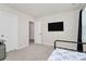 This bedroom features sleek walls, minimalist design, and is pre-wired for easy entertainment access at 913 Deep River Way, Waxhaw, NC 28173