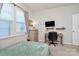 Bedroom with neutral tones, carpeted floors, window, dresser storage, and desk space at 913 Deep River Way, Waxhaw, NC 28173