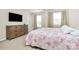 This bedroom boasts natural light, neat decor, and is equipped with modern entertainment setup at 913 Deep River Way, Waxhaw, NC 28173
