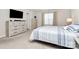 Bright bedroom with neutral tones, carpeted floors, large window, and ample dresser storage at 913 Deep River Way, Waxhaw, NC 28173