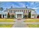 Exterior of a community house with landscaped grounds and a circular driveway at 913 Deep River Way, Waxhaw, NC 28173